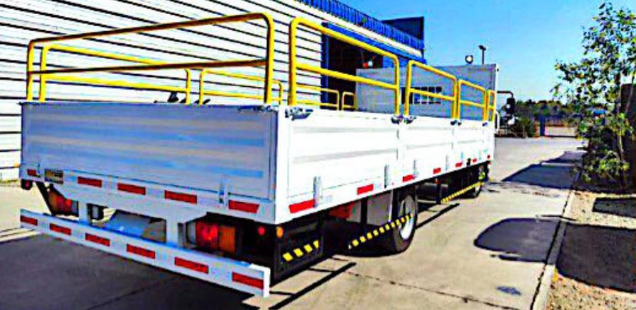 Carrocería tipo plataforma con baranda amarilla fabricada por Rocca Truck Chile